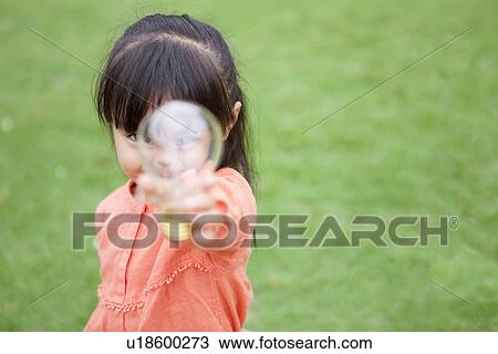 Stock Image - Girl holding a light bulb. Fotosearch