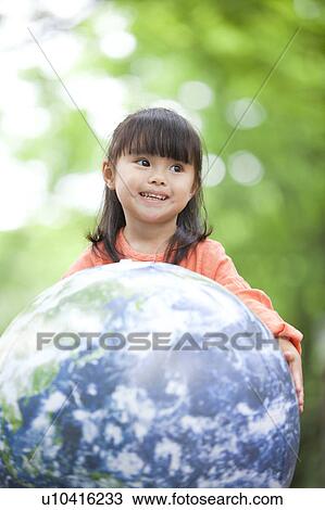 Stock Image - Girl playing with ball. Fotosearch