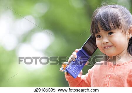 Stock Photography - Girl using a cell phone. Fotosearch