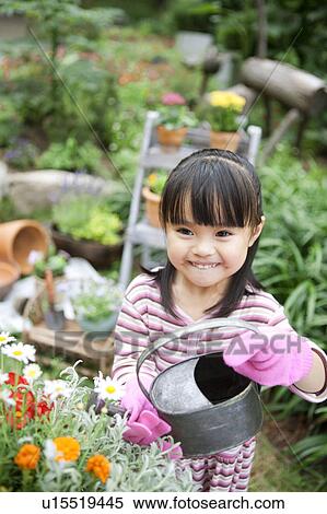 Stock Photography - Girl watering potted flower. Fotosearch