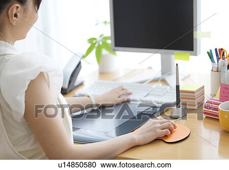 Stock Image - Graphic designer at desk. Fotosearch