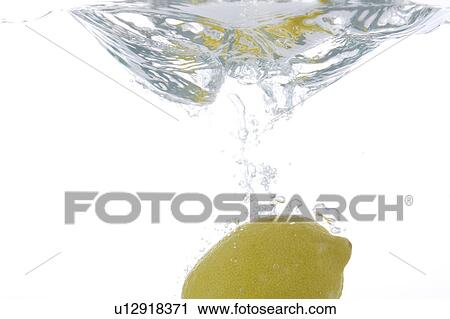 Stock Image - Lemon falling into water. Fotosearch