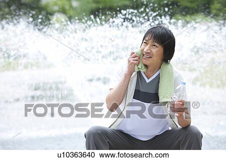 Man sitting by a fountain rubbing sweat View Large Photo Image Stock Image - Man sitting by a fountain rubbing sweat. Fotosearch