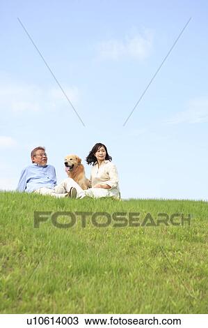 Mature Couple and Dog Sitting in Field with Dog View Large Photo Image Stock Image - Mature Couple and Dog Sitting in Field with Dog. Fotosearch