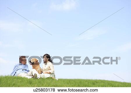 Mature Couple and Dog Sitting in Field with Dog View Large Photo Image Stock Photo - Mature Couple and Dog Sitting in Field with Dog. Fotosearch