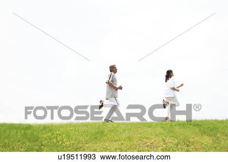 Stock Image - Mature couple jogging. Fotosearch