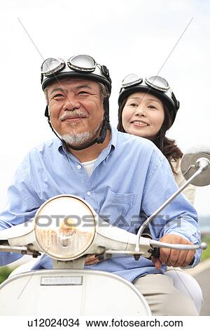 Mature couple on moped View Large Photo Image Picture - Mature couple on moped. Fotosearch