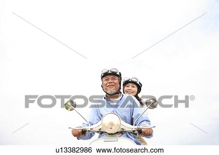 Mature couple on moped View Large Photo Image Stock Photograph - Mature couple on moped. Fotosearch