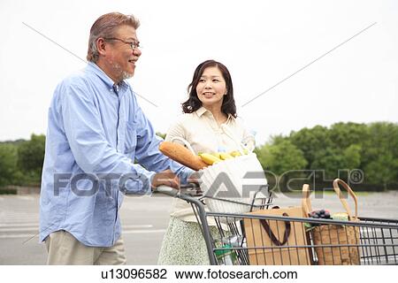 Mature Couple Pushing Shopping Cart View Large Photo Image Stock Image - Mature Couple Pushing Shopping Cart. Fotosearch