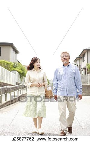 Stock Image - Mature couple walking street. Fotosearch