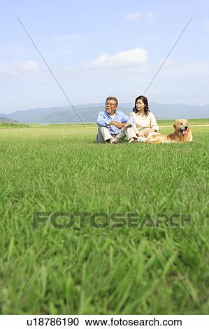 Mature Couple with Dog Sitting in Field View Large Photo Image Stock Image - Mature Couple with Dog Sitting in Field. Fotosearch
