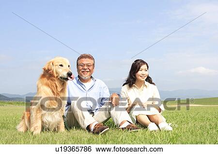 Mature Couple with Dog Sitting on Grass View Large Photo Image Stock Photograph - Mature Couple with Dog Sitting on Grass. Fotosearch