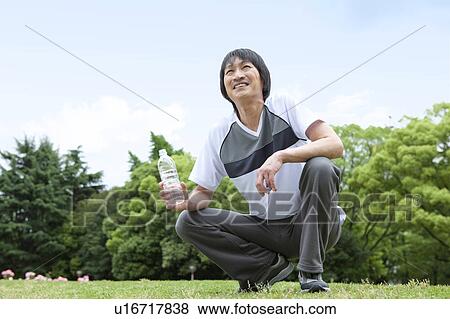 Mature man drinking water View Large Photo Image Stock Photo - Mature man drinking water. Fotosearch