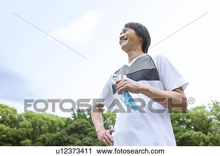 Mature man holding a jump rope View Large Photo Image Stock Image - Mature man holding a jump rope. Fotosearch
