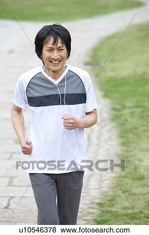 Stock Photo - Mature man jogging and listening to music. Fotosearch