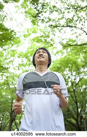 Mature man jogging and listening to music View Large Photo Image Stock Photography - Mature man jogging and listening to music. Fotosearch