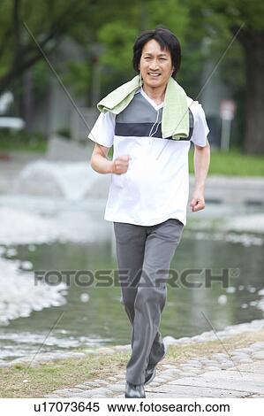Mature man jogging and listening to music View Large Photo Image Stock Photography - Mature man jogging and listening to music. Fotosearch