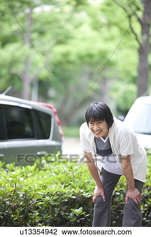 Mature man taking a break from jogging View Large Photo Image Stock Image - Mature man taking a break from jogging. Fotosearch