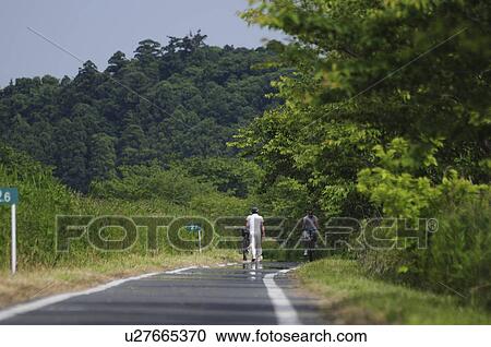 Stock Image - Men cycling, Chiba Prefecture, Honshu, Japan. Fotosearch