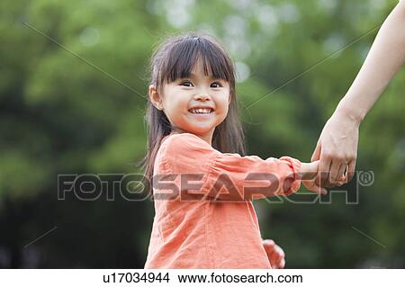 Picture - Mother and daughter holding hands. Fotosearch