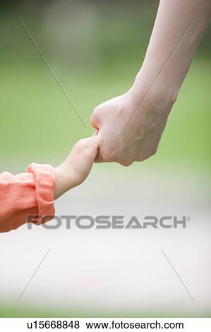 Stock Photo - Mother and daughter holding hands. Fotosearch