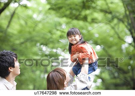 Stock Photo - Mother picking up daughter. Fotosearch