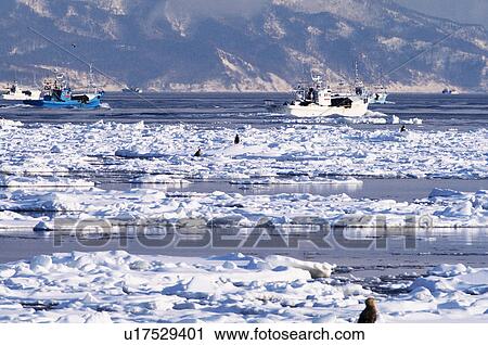 Stock Image - Nautical vessels and iceberg, Hokkaido Prefecture, Japan. Fotosearch