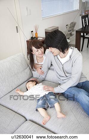 Parents Watching Baby Boy Sleeping on Sofa View Large Photo Image Stock Image - Parents Watching Baby Boy Sleeping on Sofa. Fotosearch