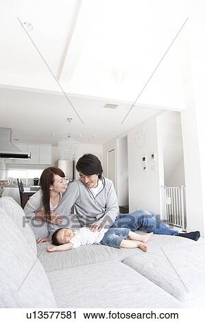 Parents Watching Baby Boy Sleeping on Sofa View Large Photo Image Stock Image - Parents Watching Baby Boy Sleeping on Sofa. Fotosearch