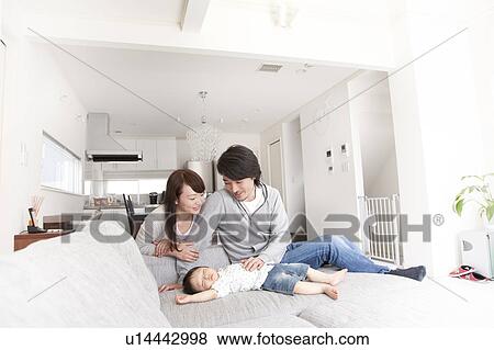 Parents Watching Baby Boy Sleeping on Sofa View Large Photo Image Stock Photo - Parents Watching Baby Boy Sleeping on Sofa. Fotosearch