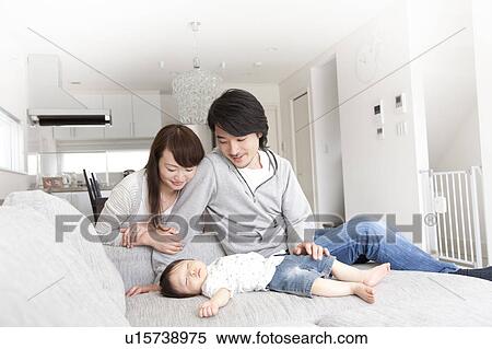 Stock Photography - Parents Watching Baby Boy Sleeping. Fotosearch