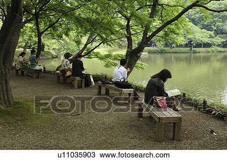 Stock Image - People relaxing at Koishikawa Korakuen Garden, Bunkyo Ward, Tokyo Prefecture, Japan. Fotosearch