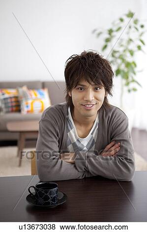 Portrait of a young man with crossed arms View Large Photo Image Stock Photo - Portrait of a young man with crossed arms. Fotosearch