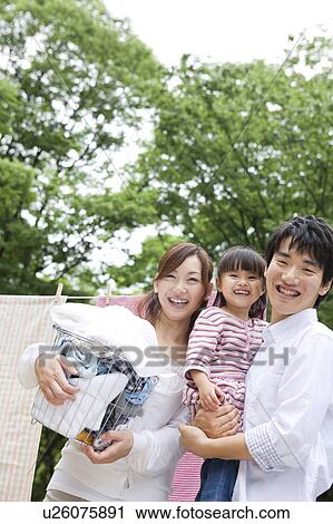 Portrait of family in front of clothesline View Large Photo Image Stock Image - Portrait of family in front of clothesline. Fotosearch