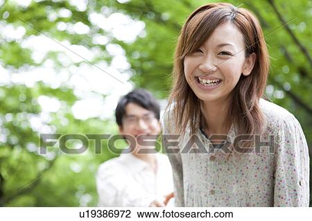 Stock Image - Portrait of young woman, focus on foreground. Fotosearch