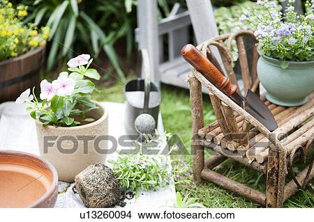 Potted flowers and gardening equipments View Large Photo Image Picture - Potted flowers and gardening equipments. Fotosearch