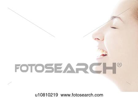 Stock Photo - Profile of a young woman smiling. Fotosearch