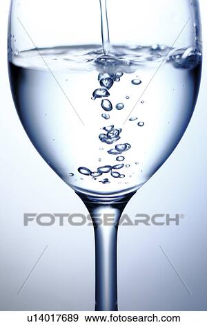 Stock Photo - Water Being Poured Into Glass. Fotosearch
