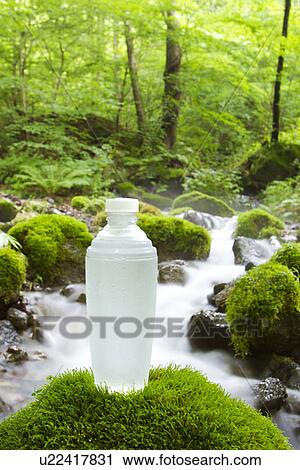 Stock Image - Water Bottle at Stream. Fotosearch