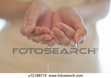 Picture - Water in Young Woman's Cupped Hands. Fotosearch