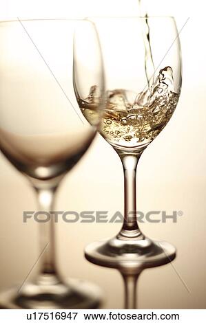Stock Photo - White Wine Being Poured Into Glass. Fotosearch