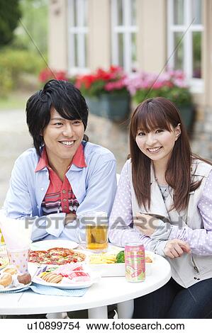 Young couple eating at an outdoor cafe View Large Photo Image Picture - Young couple eating at an outdoor cafe. Fotosearch