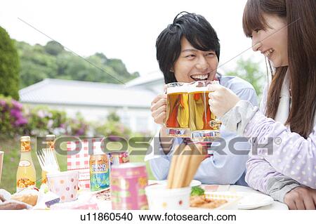Young couple toasting with beer View Large Photo Image Stock Image - Young couple toasting with beer. Fotosearch