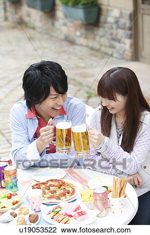 Young couple toasting with beer View Large Photo Image Stock Image - Young couple toasting with beer. Fotosearch