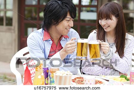 Young couple toasting with beer View Large Photo Image Stock Photography - Young couple toasting with beer. Fotosearch