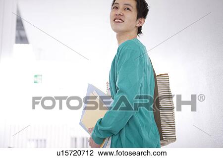 Stock Image - Young man at corridor. Fotosearch