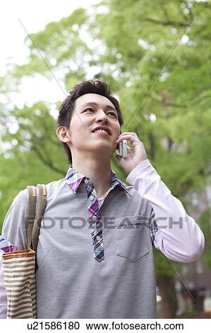 Young man on cell phone View Large Photo Image Stock Image - Young man on cell phone. Fotosearch