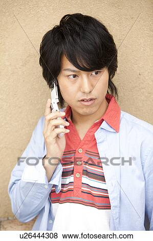 Young man on cell phone View Large Photo Image Stock Photo - Young man on cell phone. Fotosearch