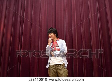 Young man standing on stage View Large Photo Image Stock Image - Young man standing on stage. Fotosearch