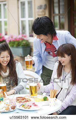 Young people drinking beer outdoors View Large Photo Image Stock Image - Young people drinking beer outdoors. Fotosearch